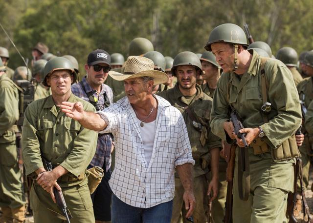 This image released by Summit shows director Mel Gibson, centre, and actor Vince Vaughn on the set of the film, Hacksaw Ridge. (AP) This image released by Summit shows director Mel Gibson, centre, and actor Vince Vaughn on the set of the film, Hacksaw Ridge. (AP)