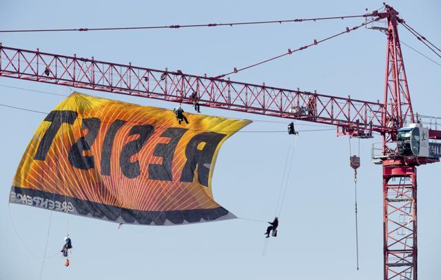 Police say protesters climbed a crane at the site refusing to allow workers to work in the area. (AP Photo) Police say protesters climbed a crane at the site refusing to allow workers to work in the area. (AP Photo)