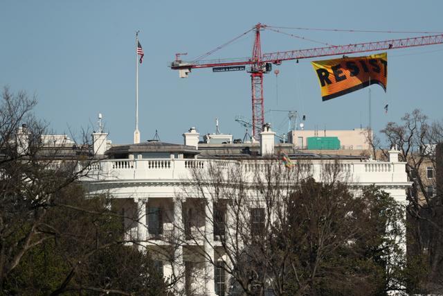 Greenpeace protesters unfurl a banner that reads "Resist" at the construction site of the former Washington Post building, near the White House in Washington. (AP Photo) Greenpeace protesters unfurl a banner that reads "Resist" at the construction site of the former Washington Post building, near the White House in Washington. (AP Photo)