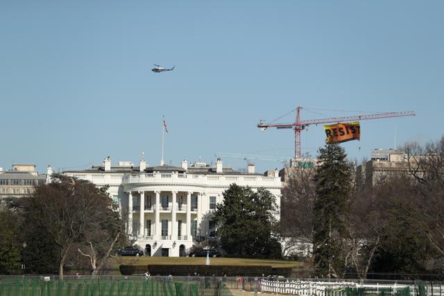 Greenpeace protesters unfurl a banner that reads "Resist". (AP Photo) Greenpeace protesters unfurl a banner that reads "Resist". (AP Photo)