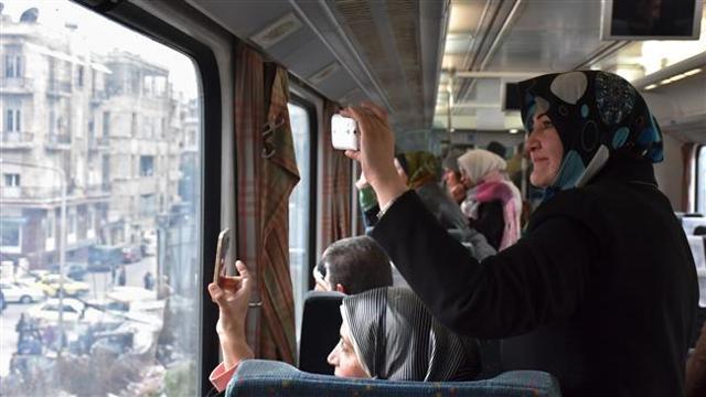 Syrian women take pictures as they ride a train traveling through Aleppo’s devastated eastern districts for the first time in more than four years, January 25, 2017. (AFP Photo) Syrian women take pictures as they ride a train traveling through Aleppo’s devastated eastern districts for the first time in more than four years, January 25, 2017. (AFP Photo)