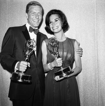 This May 25, 1964 file photo shows Dick Van Dyke, left, and Mary Tyler Moore, co-stars of The Dick Van Dyke Show backstage at the Palladium with their Emmys for best actor and actress in a series at the Television Academy's 16th annual awards show, in Los Angeles. (AP)