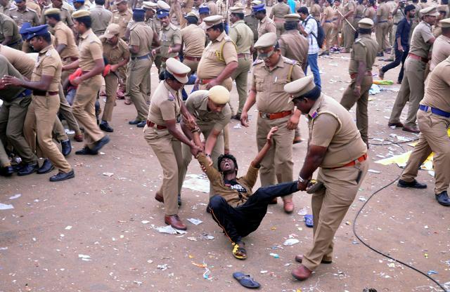 Police remove a demonstrator from Marina Beach. (Reuters Photo) Police remove a demonstrator from Marina Beach. (Reuters Photo)