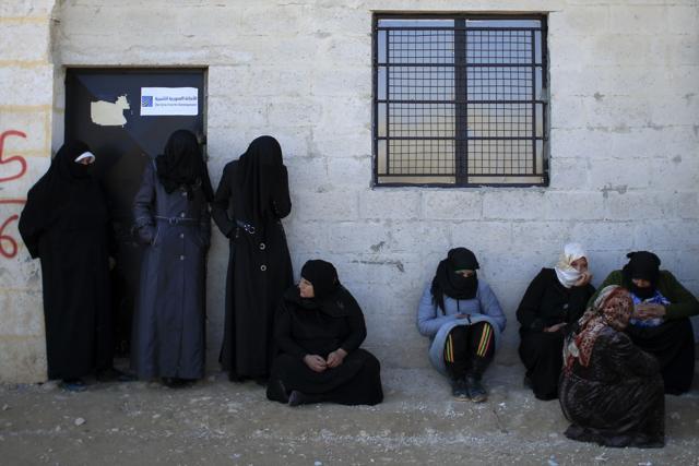 Women stand outside the Free Legal Support Program office in the shelter in Jibreen, Syria. (AP Photo) Women stand outside the Free Legal Support Program office in the shelter in Jibreen, Syria. (AP Photo)