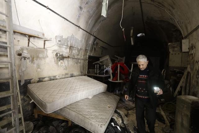 Tony checks the damage as he returns to his store, alongside other shopkeepers, for the first time to clear the debris left behind by years of fighting. (AFP) Tony checks the damage as he returns to his store, alongside other shopkeepers, for the first time to clear the debris left behind by years of fighting. (AFP)