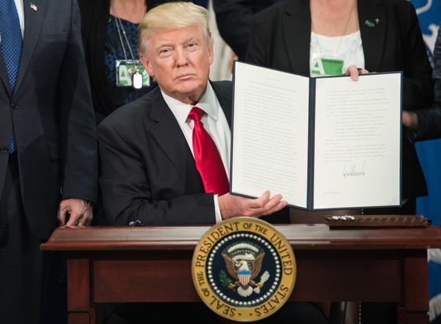 US President Donald Trump signs an executive order to start the Mexico border wall project at the Department of Homeland Security facility in Washington, DC. (AFP Photo) US President Donald Trump signs an executive order to start the Mexico border wall project at the Department of Homeland Security facility in Washington, DC. (AFP Photo)