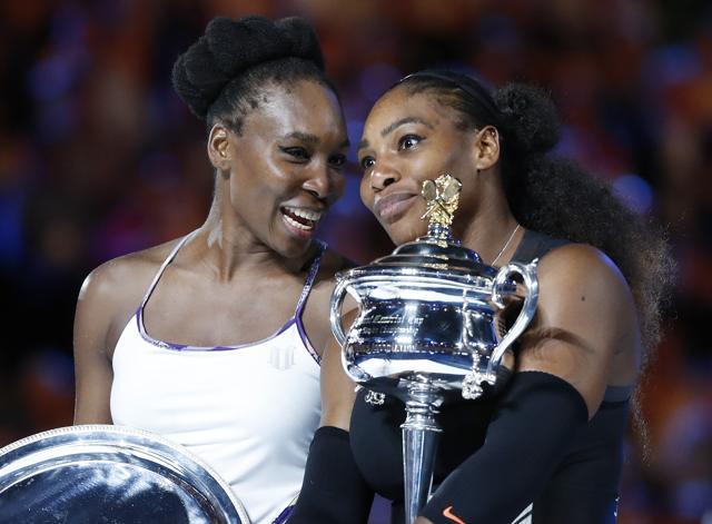 Serena Williams, right, and her sister, Venus, hold their trophies after Serena won the women's singles final at the Australian Open tennis championships in Melbourne on Saturday. (AP) Serena Williams, right, and her sister, Venus, hold their trophies after Serena won the women's singles final at the Australian Open tennis championships in Melbourne on Saturday. (AP)