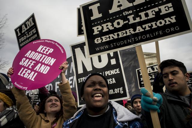Anti-abortion and pro-choice demonstrators next each other outside the Supreme Court during the anti-abortion March for Life rally in Washington. (NYT) Anti-abortion and pro-choice demonstrators next each other outside the Supreme Court during the anti-abortion March for Life rally in Washington. (NYT)
