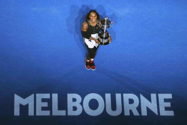 Serena Williams holds her trophy after winning the Australian Open women's singles final match against Venus Williams on Saturday. (REUTERS) Serena Williams holds her trophy after winning the Australian Open women's singles final match against Venus Williams on Saturday. (REUTERS)