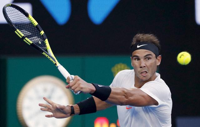 Spain's Rafael Nadal plays a backhand to Switzerland's Roger Federer during the men's singles final at the Australian Open tennis championships in Melbourne. Federer won the opening set. (AP) Spain's Rafael Nadal plays a backhand to Switzerland's Roger Federer during the men's singles final at the Australian Open tennis championships in Melbourne. Federer won the opening set. (AP)