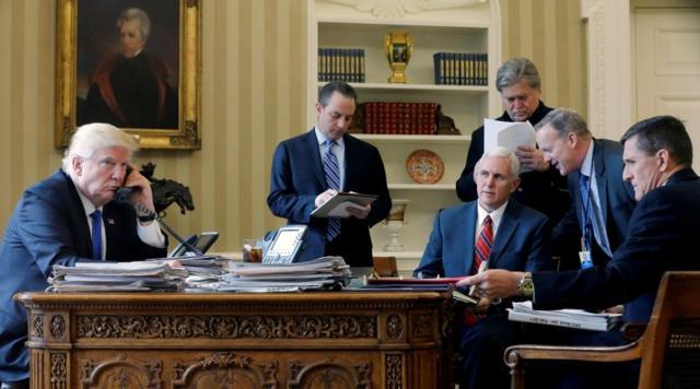 US President Donald Trump, joined by (left to right) chief of staff Reince Priebus, vice-president Mike Pence, senior advisor Steve Bannon, communications director Sean Spicer and national security advisor Michael Flynn, speaks by phone with Russia's President Vladimir Putin in the Oval Office at the White House in Washington. (Reuters) US President Donald Trump, joined by (left to right) chief of staff Reince Priebus, vice-president Mike Pence, senior advisor Steve Bannon, communications director Sean Spicer and national security advisor Michael Flynn, speaks by phone with Russia's President Vladimir Putin in the Oval Office at the White House in Washington. (Reuters)