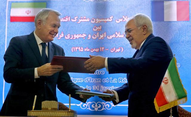 French foreign minister Jean-Marc Ayrault (left) and Iranian foreign minister Mohammad Javad Zarif exchange documents after signing economic agreements in Tehran on Tuesday. (AFP) French foreign minister Jean-Marc Ayrault (left) and Iranian foreign minister Mohammad Javad Zarif exchange documents after signing economic agreements in Tehran on Tuesday. (AFP)