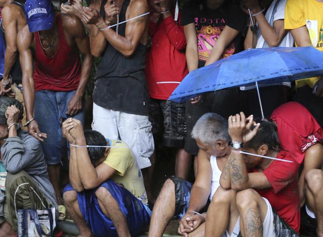 Filipino men rounded up following a police raid at an alleged drug den as part of the "War on Drugs" campaign of Philippine President Rodrigo Duterte in Quezon city, north of Manila. (AP File) Filipino men rounded up following a police raid at an alleged drug den as part of the "War on Drugs" campaign of Philippine President Rodrigo Duterte in Quezon city, north of Manila. (AP File)
