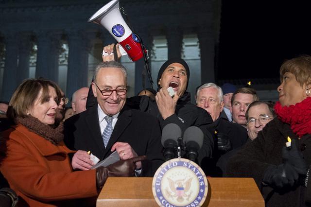 US senator Cory Booker (C), Democrat of New Jersey, speaks alongside senate minority leader Chuck Schumer (2nd L), Democrat of New York, US house democratic leader Nancy Pelosi (L) and other members of Congress as demonstrators protest against US President Donald Trump's immigration ban. (AFP photo) US senator Cory Booker (C), Democrat of New Jersey, speaks alongside senate minority leader Chuck Schumer (2nd L), Democrat of New York, US house democratic leader Nancy Pelosi (L) and other members of Congress as demonstrators protest against US President Donald Trump's immigration ban. (AFP photo)
