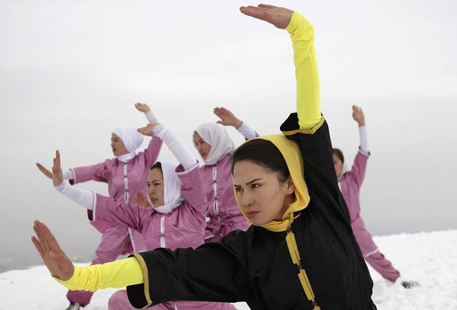 Shaolin martial arts students follow their trainer, Sima Azimi, 20, in black, during a practice session on a hilltop in Kabul. (AP) Shaolin martial arts students follow their trainer, Sima Azimi, 20, in black, during a practice session on a hilltop in Kabul. (AP)