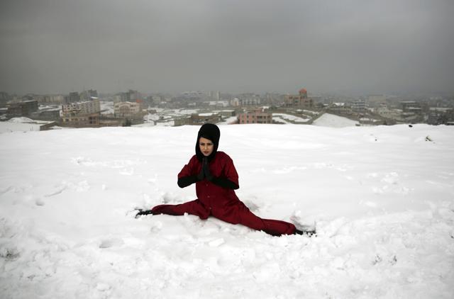 A Shaolin martial arts student practices the splits on a hilltop in Kabul, Afghanistan. (AP Photo) A Shaolin martial arts student practices the splits on a hilltop in Kabul, Afghanistan. (AP Photo)
