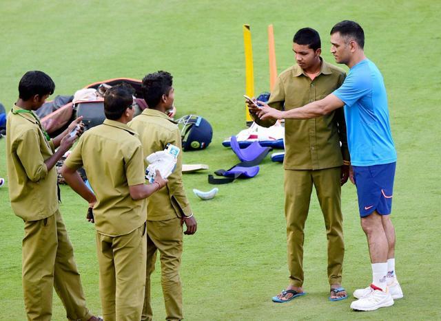 MS Dhoni obliges a groundsman for selfie during a practice session ahead of 3rd T20 match against England at Chinnaswamy stadium. (PTI)