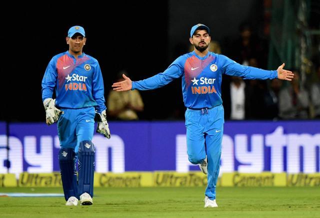 Virat Kohli celebrates the win over England at Chinnaswamy Stadium in Bengaluru on Wednesday as Mahendra Singh Dhoni watches. (PTI) Virat Kohli celebrates the win over England at Chinnaswamy Stadium in Bengaluru on Wednesday as Mahendra Singh Dhoni watches. (PTI)