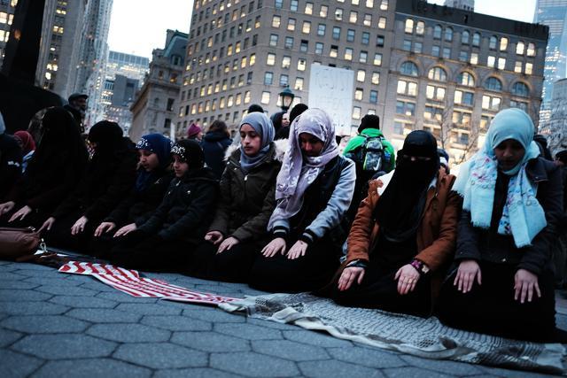 Muslim women pray before a protest on February 1 in lower Manhattan in New York City against the policies of President Donald Trump . (AFP) Muslim women pray before a protest on February 1 in lower Manhattan in New York City against the policies of President Donald Trump . (AFP)