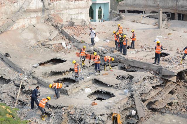 Rescue work in progress at the site of the collapsed under-construction building in Chakeri, Kanpur. (PTI Photo)