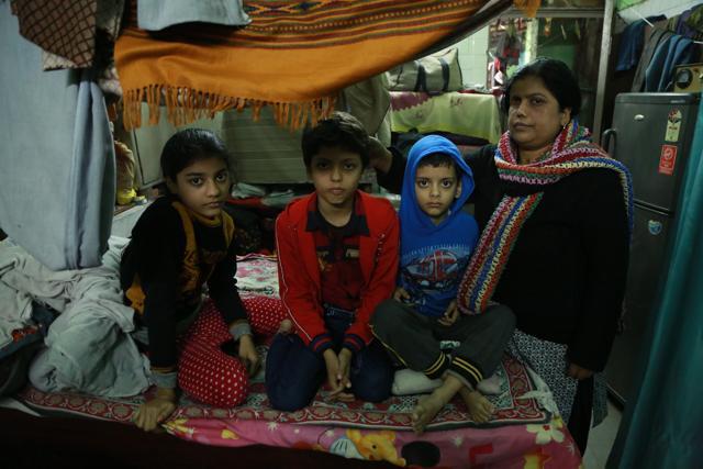 A mother stands with her children. (AmalKS/HTPHOTO)
