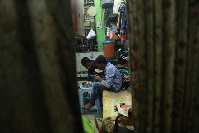 Two boys sit and play with a mobile phone in their room. (AmalKS/HTPHOTO)