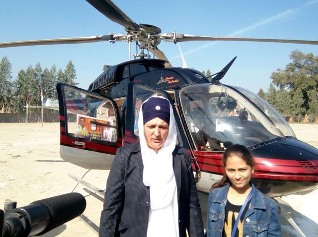 Independent candidate Rajdeep Kaur, sister of slain gangster Rocky, next to her campaign chopper in Fazilka. (HT Photo)
