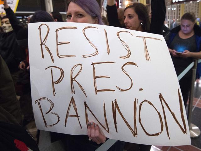 People hold up signs during a protest against US President Donald Trump's immigration rules at the Regan National Airport in Arlington, Virginia on February 1, 2017. (AFP Photo) People hold up signs during a protest against US President Donald Trump's immigration rules at the Regan National Airport in Arlington, Virginia on February 1, 2017. (AFP Photo)