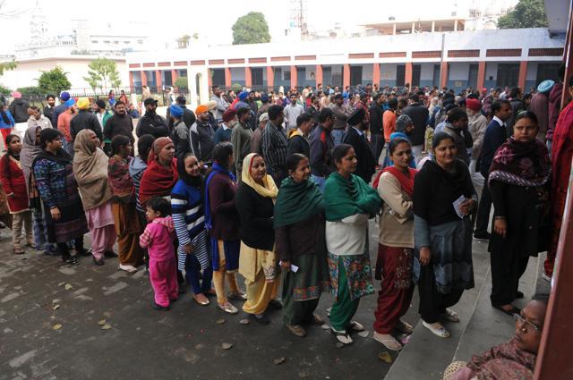 Voters standing in queues, waiting for their turn to cast vote in Jalandhar on Saturday. (Pardeep Pandit/HT Photo)