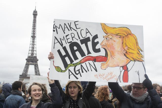 People hold a banner reading "Make America hate again" during a gathering at Trocadero Plaza next to the Eiffel Tower in Paris, to protest Donald Trump's recent travel ban to the US. (AP) People hold a banner reading "Make America hate again" during a gathering at Trocadero Plaza next to the Eiffel Tower in Paris, to protest Donald Trump's recent travel ban to the US. (AP)