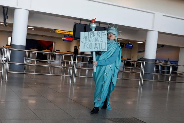 Lindley Hamlon, dressed as the Statue of Liberty, greets international travellers at the John F Kennedy international airport in New York City, US on Saturday. (Reuters photo) Lindley Hamlon, dressed as the Statue of Liberty, greets international travellers at the John F Kennedy international airport in New York City, US on Saturday. (Reuters photo)