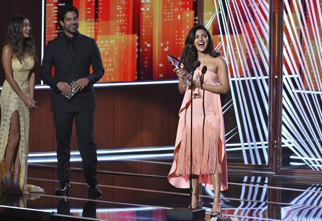 Jamie Chung and Adam Rodriguez look on from left as Priyanka Chopra accepts the award for favourite TV drama actress at the People's Choice Awards. (AP) Jamie Chung and Adam Rodriguez look on from left as Priyanka Chopra accepts the award for favourite TV drama actress at the People's Choice Awards. (AP)