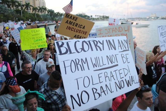 People protest outside the Trump Plaza Hotel against the executive orders issued by US President Donald Trump, in West Palm Beach, Florida. (AFP Photo) People protest outside the Trump Plaza Hotel against the executive orders issued by US President Donald Trump, in West Palm Beach, Florida. (AFP Photo)