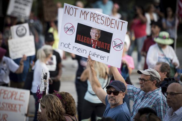 Protesters outside Trump Plaza in West Palm Beach, Flordia. (AP Photo) Protesters outside Trump Plaza in West Palm Beach, Flordia. (AP Photo)