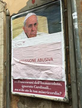 A paper sheet with writing in Italian reading ‘iIlegal posting’ covers an anti-Pope Francis poster in central Rome. (AP photo) A paper sheet with writing in Italian reading ‘iIlegal posting’ covers an anti-Pope Francis poster in central Rome. (AP photo)