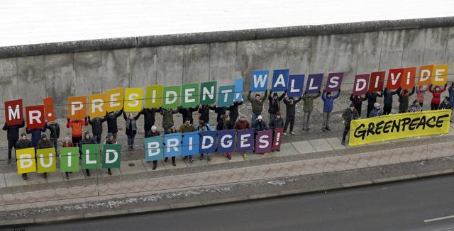 Protesters of the environmental organization 'Greenpeace' display placards showing a slogan at the Berlin Wall Memorial in Berlin. (AP Photo) Protesters of the environmental organization 'Greenpeace' display placards showing a slogan at the Berlin Wall Memorial in Berlin. (AP Photo)