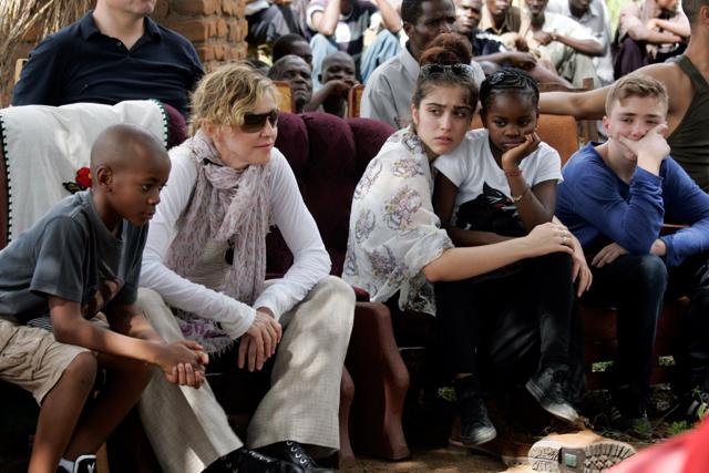This file photo taken on April 2, 2013 shows US Pop Star Madonna (2nd L) sitting with her biological and adopted children (L to R) David Banda, Lourdes, Mercy James, and Rocco at Mkoko Primary School, one of the schools Madonna's Raising Malawi organization has built jointly with US organization BuildOn, during a visit in the region of Kasungu, central Malawi. (AFP) This file photo taken on April 2, 2013 shows US Pop Star Madonna (2nd L) sitting with her biological and adopted children (L to R) David Banda, Lourdes, Mercy James, and Rocco at Mkoko Primary School, one of the schools Madonna's Raising Malawi organization has built jointly with US organization BuildOn, during a visit in the region of Kasungu, central Malawi. (AFP)