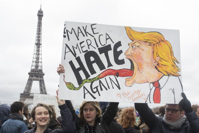 People hold a banner reading "Make America hate again" during a gathering to protest US President Donald Trump's recent travel ban to the US at Trocadero Plaza next to the Eiffel Tower in Paris. (AP Photo) People hold a banner reading "Make America hate again" during a gathering to protest US President Donald Trump's recent travel ban to the US at Trocadero Plaza next to the Eiffel Tower in Paris. (AP Photo)