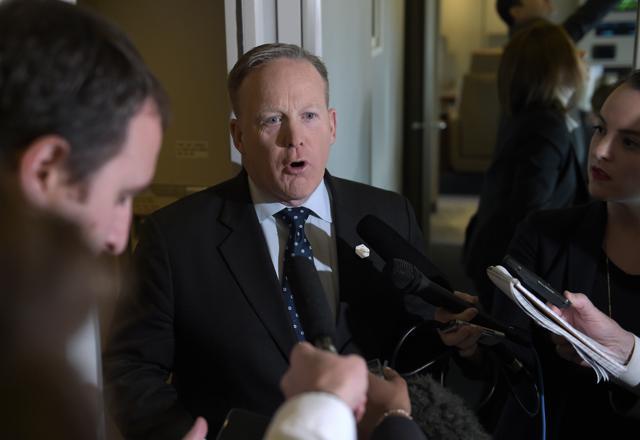White House press secretary Sean Spicer speaks to reporters on board Air Force One over Maryland. (AP photo)