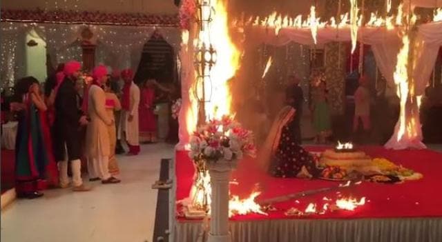 Jennifer sitting in the mandap as other actors watch behind her. (Instagram)