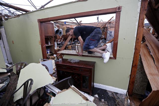 Gregory Rugon climbs out of his home after failing to find his glasses that he lost taking cover after a tornado hit his Warren Drive home, in the New Orleans East section of New Orleans, on February 7, 2017. (AP) Gregory Rugon climbs out of his home after failing to find his glasses that he lost taking cover after a tornado hit his Warren Drive home, in the New Orleans East section of New Orleans, on February 7, 2017. (AP)
