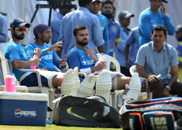 India's cricket captain Virat Kohli (C) looks on as teammates bat in the nets. (AFP)