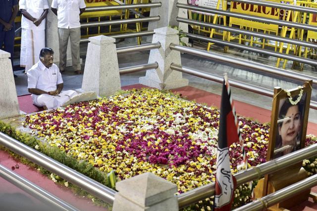 O Panneerselvam meditates in front of late J Jayalalithaa's burial site at the Marina Beach in Chennai. (PTI Photo)