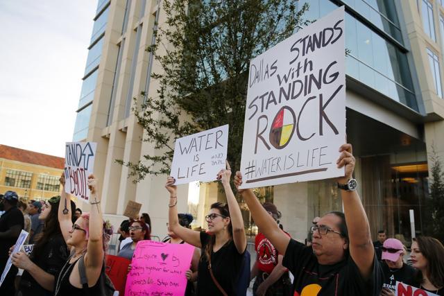 People standing outside developer Energy Transfer Partners headquarters protest the Army Corps of Engineers approval of the final section of the Dakota Access oil pipeline. (AP Photo)