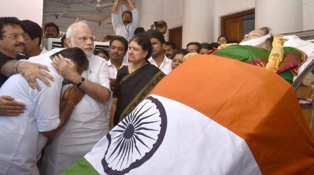Prime Minister Narendra Modi consoles O Panneerselvam while paying his last respects to Jayaram Jayalalithaa at Rajaji Hall in Chennai. Sasikala (right) looks on. (PTI Photo)
