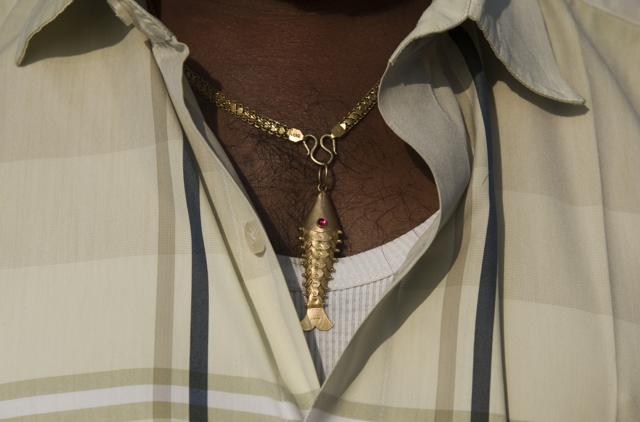 A fisherman at the Bharathi Nagar beach wears a fish locket in Chennai. (Saumya Khandelwal/HT PHOTO)
