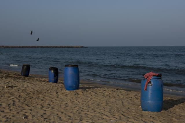 Barrels of oil and sludge collected after cleaning operations lie on KVK Kuppum Beach in Chennai. (Saumya Khandelwal/HT PHOTO)