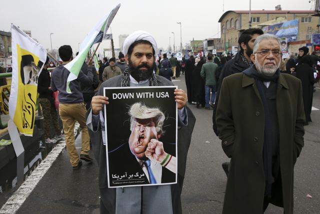 A cleric holds a caricature of US President Donald Trump in an annual rally commemorating the 1979 Islamic revolution. (AP) A cleric holds a caricature of US President Donald Trump in an annual rally commemorating the 1979 Islamic revolution. (AP)