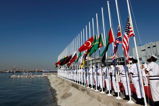 Pakistan Navy personnel hoist the national flags of participating countries during the opening ceremony of Aman-17 in Karachi. (REUTERS) Pakistan Navy personnel hoist the national flags of participating countries during the opening ceremony of Aman-17 in Karachi. (REUTERS)