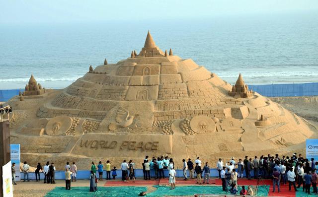 Sand artist Sudarshan Pattnaik makes a sand added yet another feature in his cap by storming into Guinness World Records for having created the world's tallest sand castle on Puri beach in Odisha on Friday. (PTI Photo) Sand artist Sudarshan Pattnaik makes a sand added yet another feature in his cap by storming into Guinness World Records for having created the world's tallest sand castle on Puri beach in Odisha on Friday. (PTI Photo)